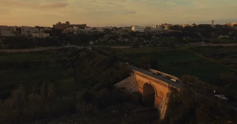 Aerial shot during sunset flying towards a small bridge Stock Footage 73465880