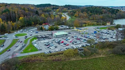 Aerial Shot of E6 Highway Interchange and Crowded Parking Lot by Roadside Stock-Footage 337250746