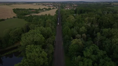 Aerial shot of electric train approaching at twilight Stock Footage 264187142