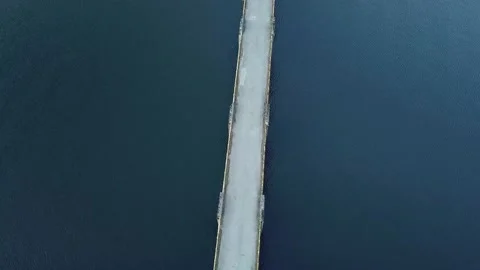 Aerial shot in elevation of a bridge that crosses a river Stockbeeldmateriaal 169075261