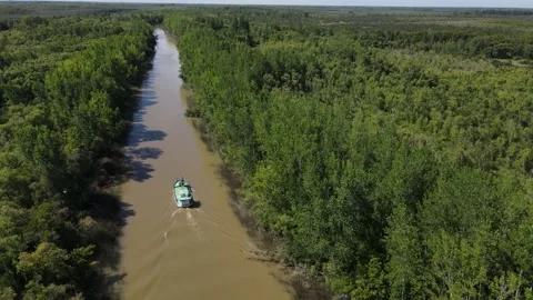 Aerial shot of empty cargo ship through narrow steam in Amazon River Stock-Footage 151976729