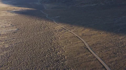 Aerial shot of an empty road crossing a dry and arid desert, Salt Lake City, US Stock Footage 287724889