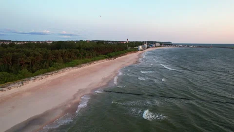 Aerial shot of empty sandy beach and green forest line. Stock Footage 338139489