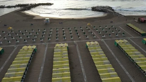 Aerial shot empty yellow beach spa and resort front to ocean and breakwater a Vidéo 152272546