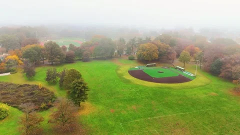 Aerial Shot of Fall Foilage. Flying over Trees into Baseball Field Stock Footage 254435201