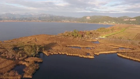 Aerial shot, fall landscape, flying above fields and a huge lake. 스톡 동영상 72070750