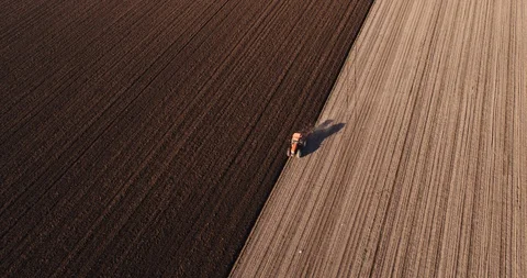 Aerial shot of a farmer plowing fields. Stock Footage 94332849