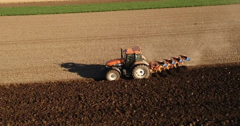 Aerial shot of a farmer plowing fields. Stock Footage 94338754