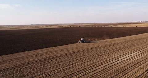 Aerial shot of a farmer plowing fields. Stock Footage 94350043