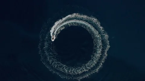 Aerial shot of a fast speedboat making beautiful circle path in the sea Stock Footage 96006727
