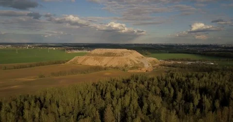 Aerial shot of the field and forest. Drone flying near the big pile of trash in Stock Footage
