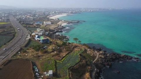 Aerial shot of fields, beach and seaside village,Jeju Island,South Korea Stock Footage 245953599