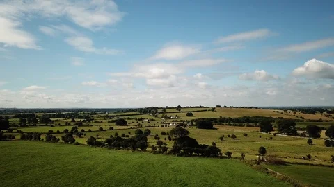 Aerial shot of fields on a warm summer day Stock Footage