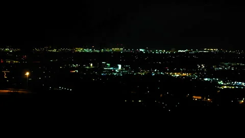 Aerial Shot Of Fireworks Exploding In Illuminated City Against Dark Clear Sky At Stock Footage 255409301