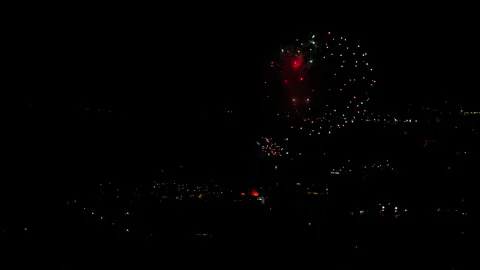 Aerial Shot Of Fireworks Exploding On Neighborhood Against Sky At Night, Drone Stock Footage 243880429