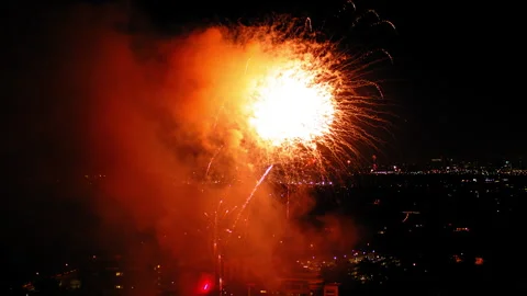Aerial Shot Of Fireworks Exploding In Neighborhood Against Sky, Drone Flying Stock Footage 243883168