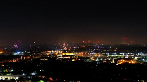 Aerial Shot Of Fireworks Exploding Over Buildings In Suburb, Drone Flying Stock Footage 243880279