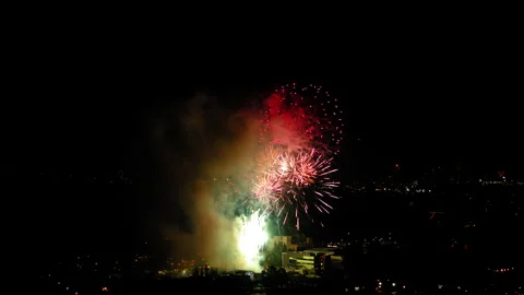 Aerial Shot Of Fireworks Exploding In Suburb Against Sky At Night, Drone Flying Stock Footage 243884377