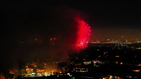 Aerial Shot Of Fireworks Exploding On Suburb In City Against Sky, Drone Flying Stock Footage 243884785