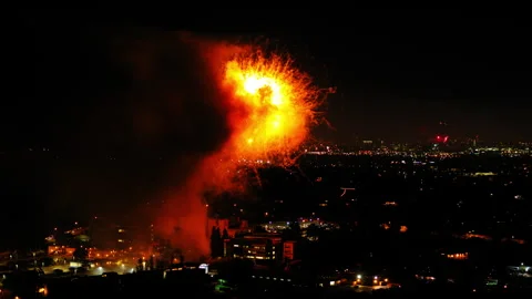 Aerial Shot Of Fireworks Exploding On Suburb In City At Night, Drone Flying Over Stock Footage 244016888