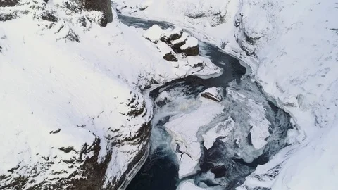 Aerial shot flies through a canyon valley covered in snow. Winter landscape. Video stock 88242574