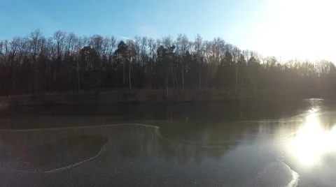 Aerial Shot: Flight over half-frozen lake Stock Footage 58044314