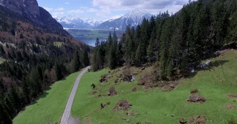 Aerial shot of a flight through a valley in the direction of a lake Stock Footage 63486181