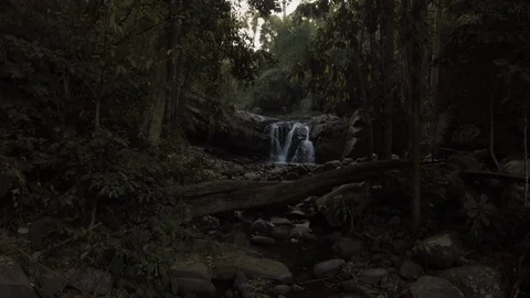 Aerial shot fly through a waterfall in tropical forest at early morning Stock Footage 86906099