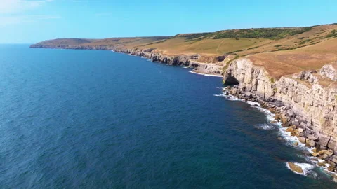Aerial shot flying along the cliffs of the Jurassic coast in Dorset Stock Footage 345281618