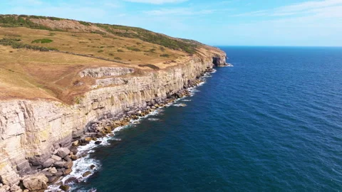 Aerial shot flying along the cliffs of the Jurassic coast in Dorset Stock Footage 345282125