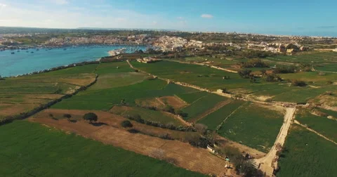 Aerial Shot - Flying backwards over green lands and blue sea Stock Footage 61282458