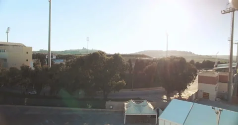 Aerial shot - Flying close to trees moving towards a football stadium Stock Footage 61772403