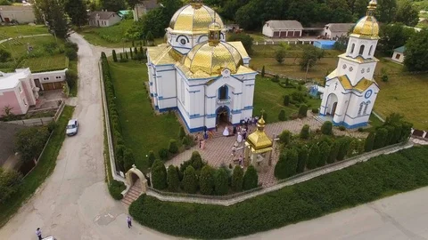 Aerial shot, flying near a domed church background village and forest Stock Footage 77798853