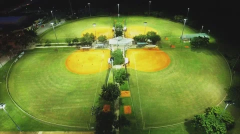 Aerial shot flying over baseball parks in the evening Stock Footage 68996741