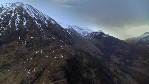 Aerial shot flying over dramatic snowy Scottish highlands Stock Footage 336797389