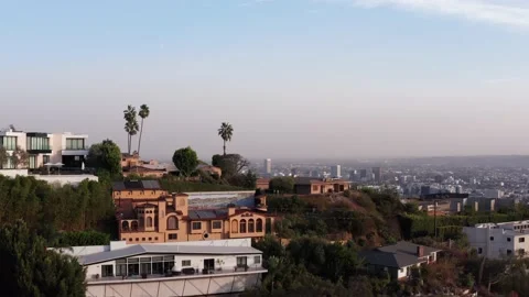 Aerial shot flying over a hill to reveal the city of Los Angeles. 4K Stock Footage