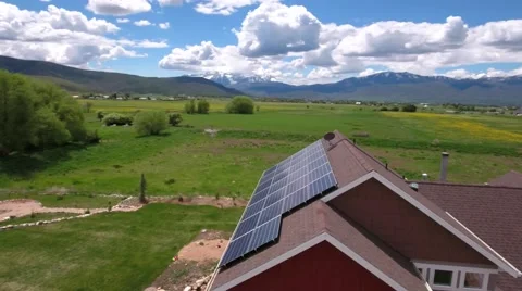 Aerial shot of flying over house with solar panels in spring Stock Footage