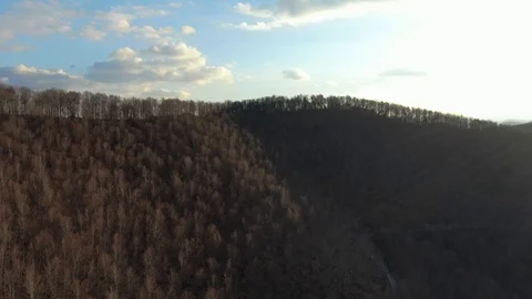 Aerial shot flying over a mountain forest in. Stock Footage