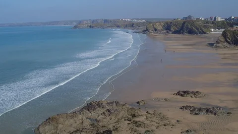 Aerial shot flying over waves and beach of Newquay, Cornwall Stock Footage