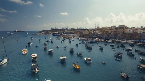 Aerial shot flying sideways over moored boats in Marsaxlokk Stock Footage 90643115