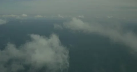 Aerial shot flying through the clouds with ocean below Stock Footage 145944239