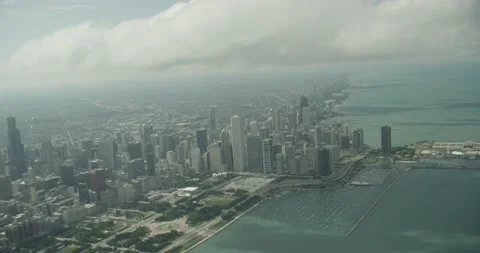 Aerial shot flying through the clouds with Chicago below Stock Footage 145949068