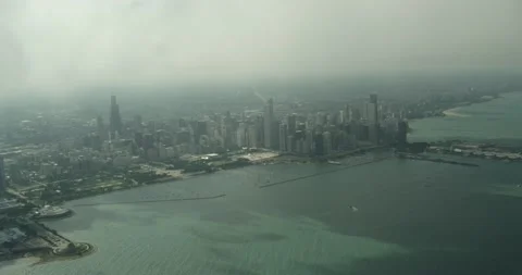Aerial shot flying through clouds revealing Chicago Stock Footage 145952144