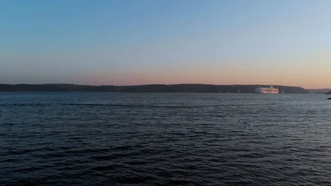 Aerial shot flying toward a moving cruise ship in a beautiful sunset Stock Footage 96390553