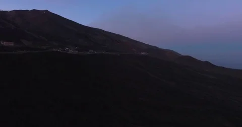 Aerial shot flying towards Mount Etna at dusk Stock Footage 77097880