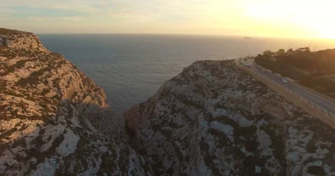 Aerial shot - Flying trough Cliffs during Sunset Stock Footage 61380409