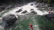 Aerial Shot Following Young Woman In Kayak Down River With White Water Rapids Stock Footage