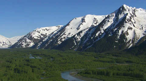 Aerial shot of forest streams and snowy mountains, Alaska Stock Footage