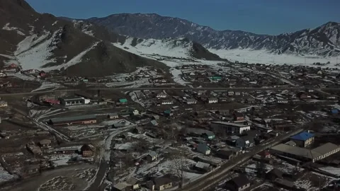 Aerial shot in forward movement of spring mountains and village in front of it Stock Footage 165594518