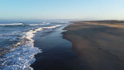 Aerial Shot forward over waves - golden hour Stock Footage 161592179